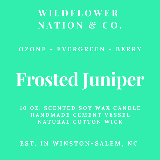 A mint green product label for a Wildflower Nation & Co. candle, featuring white text that reads 'Ozone - Evergreen - Berry' and 'Frosted Juniper' with additional product details below.