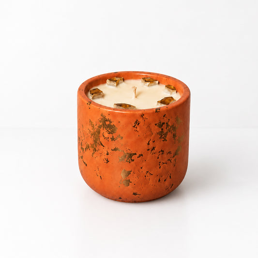 Peach Petals candle in a burnt-orange handcrafted Hydrostone vessel with gold leaf and amber Fireglass accents