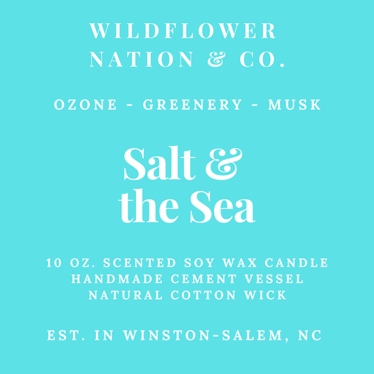 A flat turquoise label-style graphic with white text reading 'WILDFLOWER NATION & CO.' and 'Salt & the Sea,' plus scent notes 'OZONE - GREENERY - MUSK' and product details for a 10 oz.